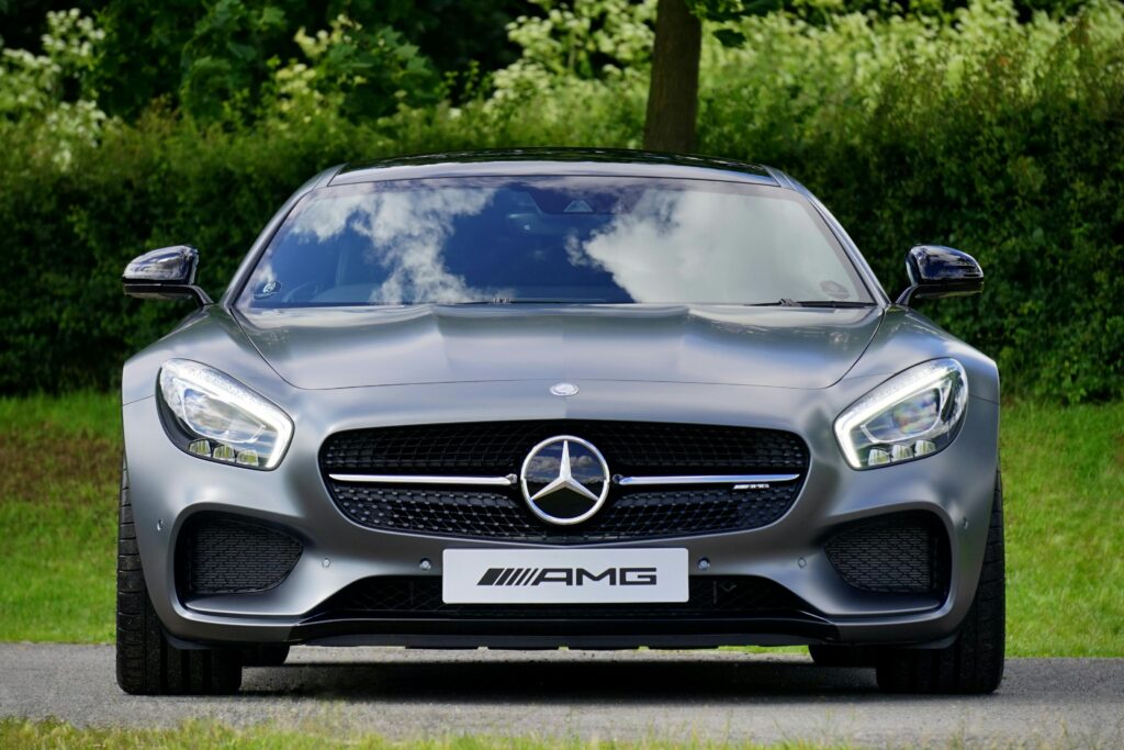 pexels-photo-112460-112460 Front view of a luxury Mercedes-Benz AMG against a natural backdrop.
