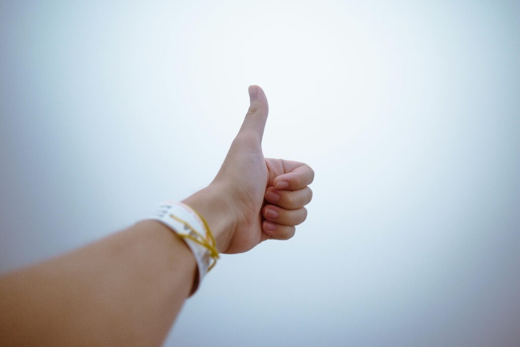 pexels-photo-193821-193821-1 A hand giving a thumbs up gesture symbolizes approval and positivity.